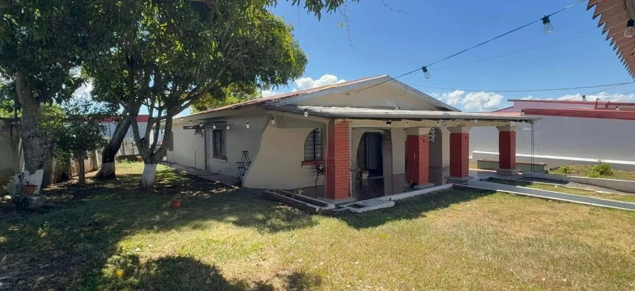 It has 4 bedrooms, 2 bathrooms, living room, dining room and kitchen, parking, lots of green area, covered patio.