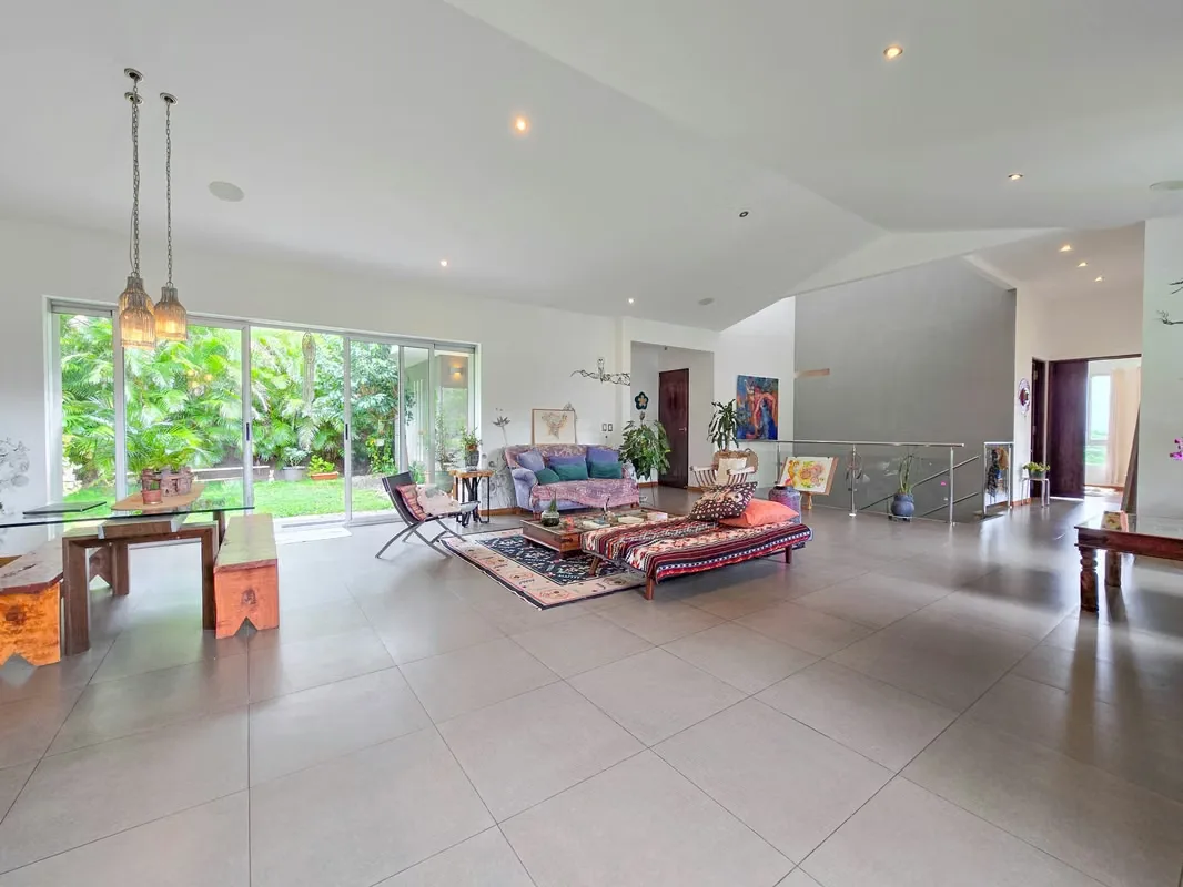 Discover this elegant corner home with contemporary modern design, located in an exclusive gated condominium in Ciudad Colon, offering beautiful city and valley views.