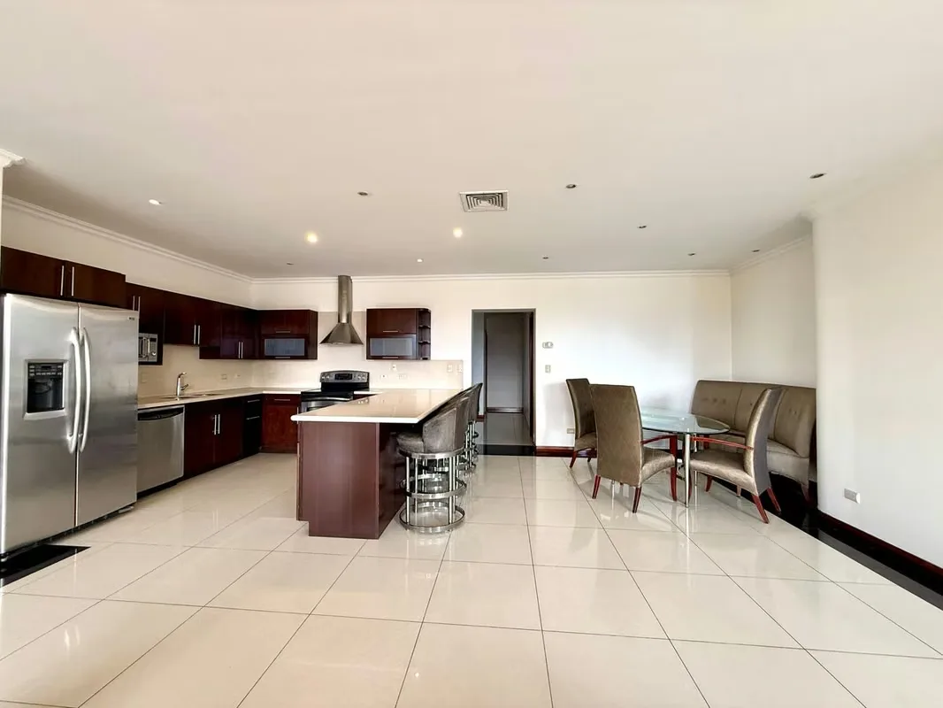 This apartment stands out for its spacious and comfortable layout. The kitchen is integrated into the social area and features a convenient breakfast bar, with direct access to a ..., photo 2