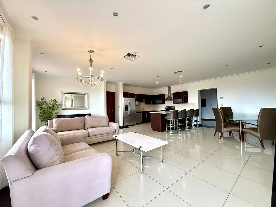 This apartment stands out for its spacious and comfortable layout. The kitchen is integrated into the social area and features a convenient breakfast bar, with direct access to a ..., photo 3