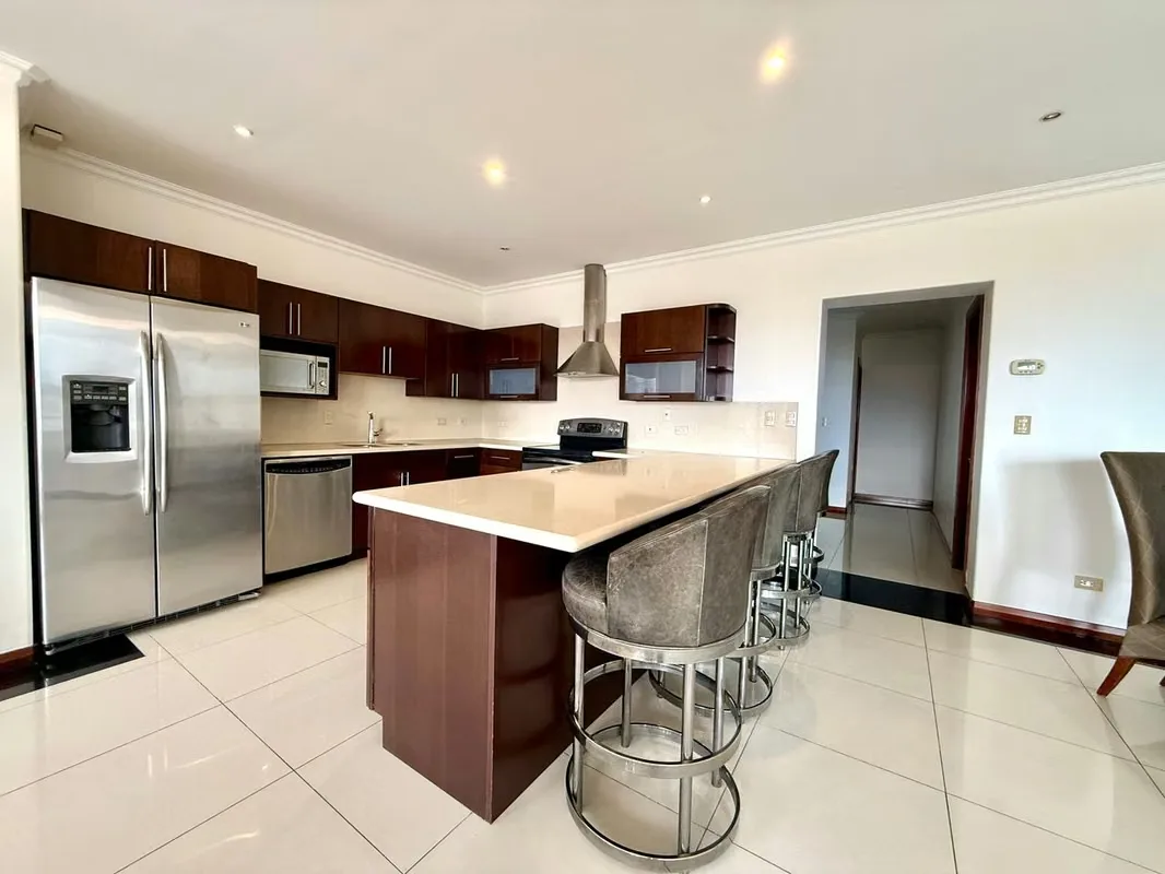 This apartment stands out for its spacious and comfortable layout. The kitchen is integrated into the social area and features a convenient breakfast bar, with direct access to a ..., photo 5