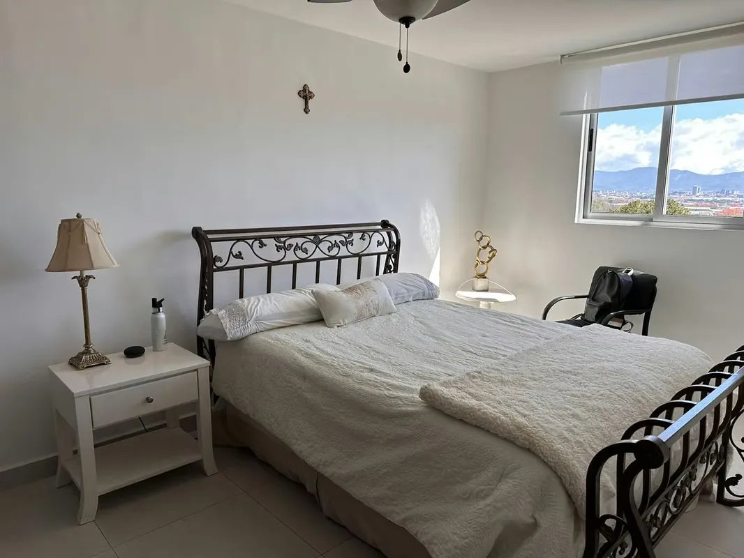 The apartment has a master bedroom with a queen bed, with a full bathroom, reading table, ..., photo 11