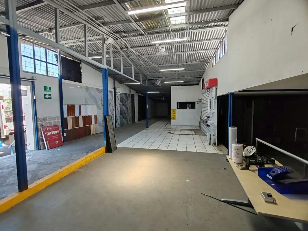 A property comprised of two lots, featuring a commercial showroom and a large warehouse with a loading area and customer parking, formerly a hardware store. Located on a main street ...