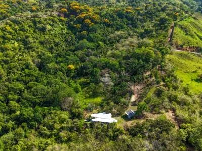 Granja autosostenible fuera de la red eléctrica cerca de Ojochal con casa, energía solar y río.